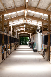 looking down the breezeway of one of the stables.